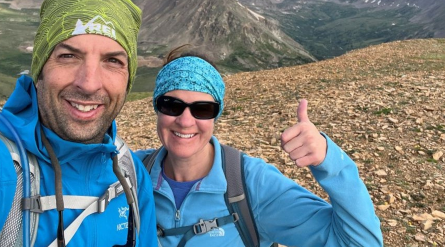 man and woman hiking a mountain